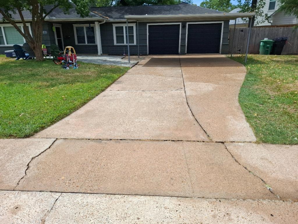 Gray house driveway after pressure washing — clean concrete